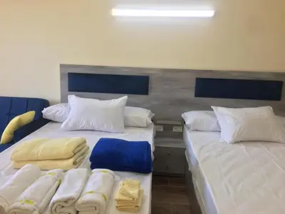 two beds sitting next to each other in a room at florenza khamsin studio in hurghada pool view in Hurghada