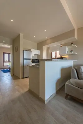 a large kitchen with a counter and a refrigerator at VESTA - El Gouna Residence in Hurghada