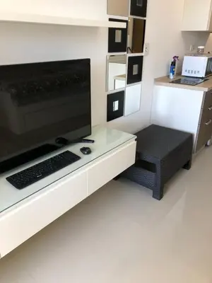 a desk with a computer monitor and a keyboard at G cribs B1F2 in Hurghada