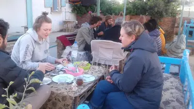 a group of people sitting around a table at Sea Waves Hostel not for Egyptian in Hurghada