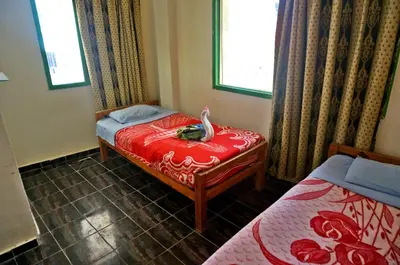 a bedroom with a bed with a swan on it at Sea Waves Hostel not for Egyptian in Hurghada
