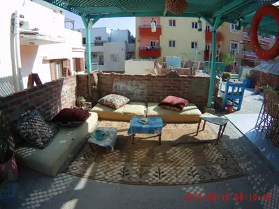 a group of couches and tables on a patio at Sea Waves Hostel not for Egyptian in Hurghada