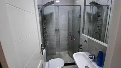 a bathroom with a shower and a toilet and a sink at Aqua Palms Studio A210 in Hurghada