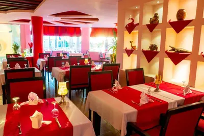 a restaurant with tables with red tablecloths at El Karma Beach Resort & Aqua Park - Hurghada in Hurghada
