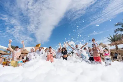 a group of people standing in a cloud of snow at El Karma Beach Resort & Aqua Park - Hurghada in Hurghada