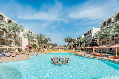 a group of people in a swimming pool at a resort at El Karma Beach Resort & Aqua Park - Hurghada in Hurghada