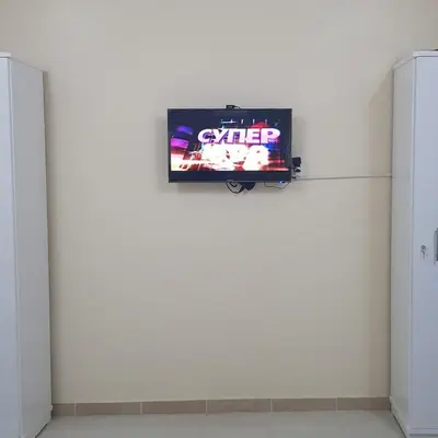 a television on a white wall in a room at Sweet Home 5 Open 24 Hour in Hurghada