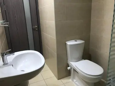 a bathroom with a white toilet and a sink at AlDau Hights one Bedroom Elegante Apartment 10201 in Hurghada