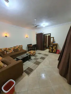a living room with a couch and a table at Abeer Suites in Hurghada