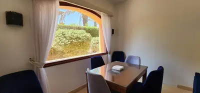 a dining room with a table and a window at Nayah Stays, Lagoons beach, Paradise 3 ensuite with private pool in El Gouna