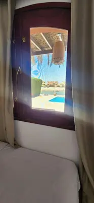a window on a train with a view of a pool at Nayah Stays, Lagoons beach, Paradise 3 ensuite with private pool in El Gouna