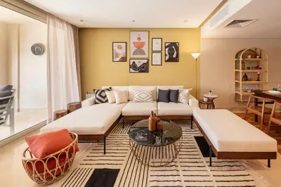 a living room with a couch and a table at Epic & Exquisite 2 BR w Beach & Pool Mangroovy in Hurghada