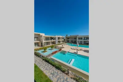 an image of a swimming pool at a resort at Cozy Studio in G-Cribs with pool - Golden Apartments El Gouna in Hurghada