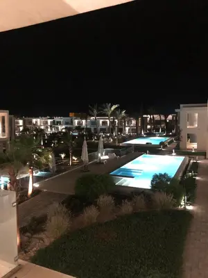 a view of a swimming pool at night at Renovated Lovely Cozy Studio in G Cribs, Elgouna in Hurghada