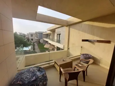 a balcony with a table and chairs and a window at Renovated Lovely Cozy Studio in G Cribs, Elgouna in Hurghada