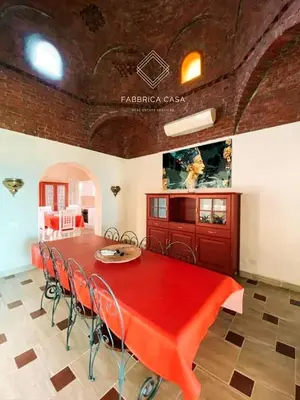 a dining room with a red table and chairs at FabbricaCasa Sea Front Villa, Oriental Coast in Marsa Alam City