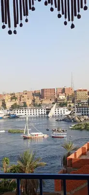 a view of a river with boats in the water at Masa Nubian House in Aswan