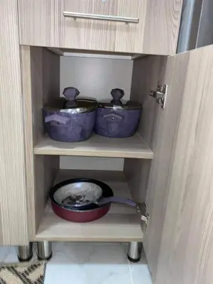 a cabinet with two pots and a bowl in it at Tiba View - Unit no B15 - near ElGouna in Hurghada