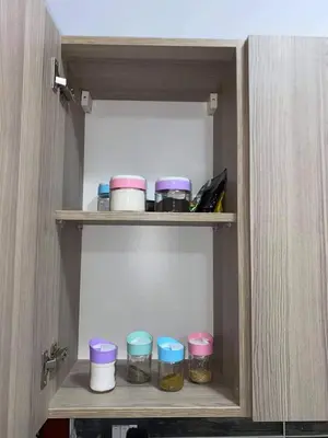 a cabinet with some jars of food in it at Tiba View - Unit no B15 - near ElGouna in Hurghada