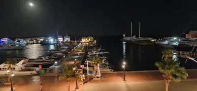 a bunch of boats docked in a marina at night at Amazing 2 bedrooms' Flat Marina El-Hurghadah in Hurghada