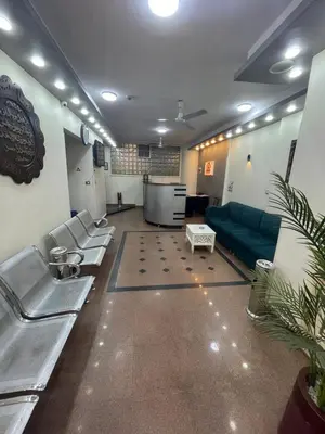 a waiting room with a couch and chairs in a room at Grand Hotel Qena in Qena