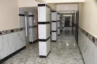 a corridor of a bathroom with white and black tiles at Tiba Hotel in Aswan