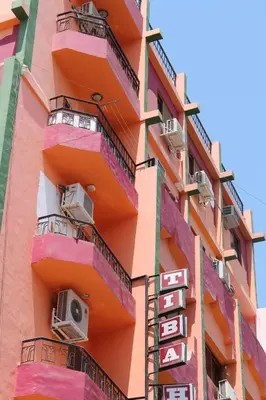 a building with balconies and a sign on it at Tiba Hotel in Aswan
