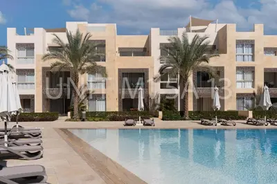 a resort with a swimming pool in front of a building at Elgouna Heart Mangroovy new 2bedrooms in Hurghada