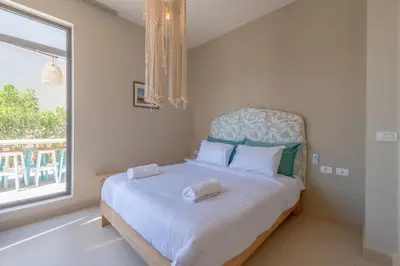 a bedroom with a large bed with a window at La Casa de Playa Tawila on Island 4BR Private with Heated Pool in Hurghada