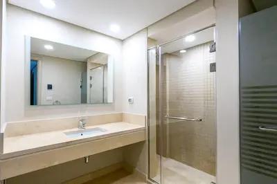 a bathroom with a sink and a shower at Mangroovy 3BR Apartment Private Beach & Pool View in Hurghada