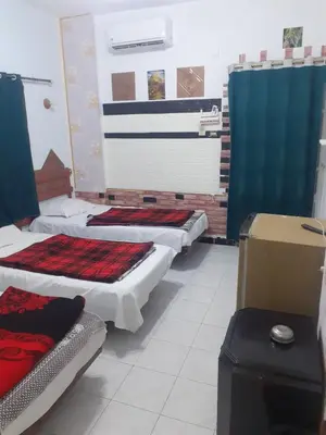 a room with three beds sitting in it at Four Seasons Hotel in Hurghada