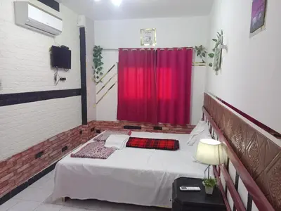 a room with a bed with a red curtain at Four Seasons Hotel in Hurghada