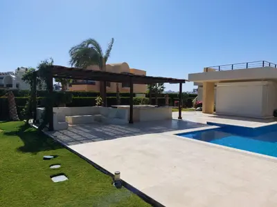 a backyard with a swimming pool and a house at El Gouna luxe in Hurghada