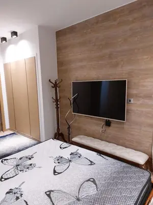 a bedroom with a bed with a flat screen tv at El Gouna luxe in Hurghada