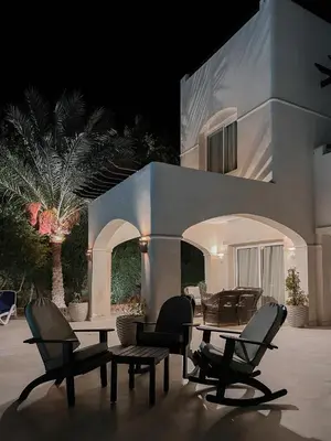 a couple of chairs and a table in front of a house at GS 18 Villa in Hurghada