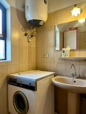 a bathroom with a washing machine and a sink at Downtown ElGouna Excellent Location in Hurghada
