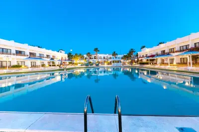 a large swimming pool in front of some buildings at The Grand Hotel, Hurghada in Hurghada