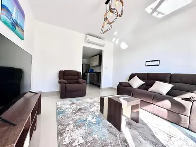 a living room with a couch and a table at G cribs 2 BR sharing Pool in Hurghada
