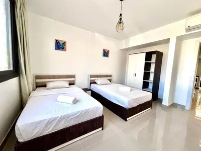 a bedroom with two beds in a room at G cribs 2 BR sharing Pool in Hurghada