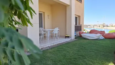 a patio with a table and chairs on a balcony at Waterside Apartments, El Gouna - 1Bd Ground Floor in El Gouna