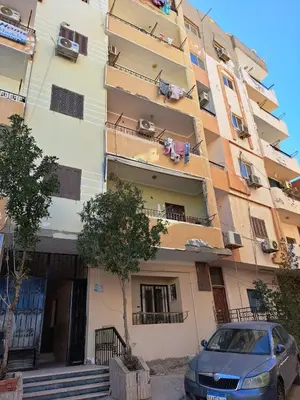 a building with a car parked in front of it at Sweet Home Hostel- ممنوع للمصريين open 24 hour in Hurghada