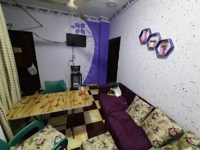 a living room with a table and a couch at App12 - RAWDA - Enjoy the privacy of staying in a quiet apartment with free Wi-Fi as your complete second home in the heart of Hurghada in Hurghada