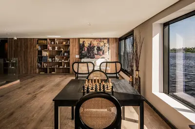 a room with a chess board and two chairs at Historia The Boutique Hotel Nile Cruise - Every Monday from Luxor for 04 & 07 Nights - Every Friday From Aswan for 03 & 07 Nights in Luxor