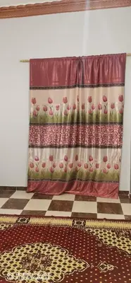 a curtain on a wall in a room with a floor at Tut flat in Luxor