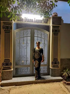 a woman is standing in front of a door at Nile diana luxor in Luxor