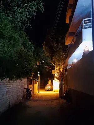 a person walking down a street at night at Nile diana luxor in Luxor