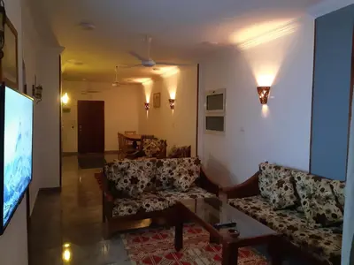 a living room with two couches and a flat screen tv at German Dolphin in Quseir