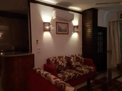 a living room with a couch and lights on the wall at German Dolphin in Quseir