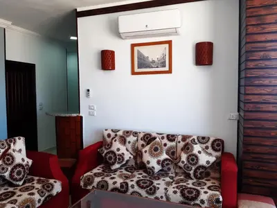 a living room with a couch and a picture on the wall at German Dolphin in Quseir
