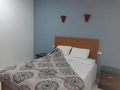 a bedroom with a bed with a quilt on it at German Dolphin in Quseir